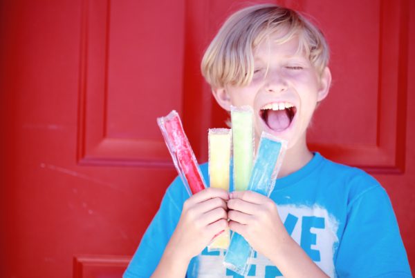 smiling boy with popsicles