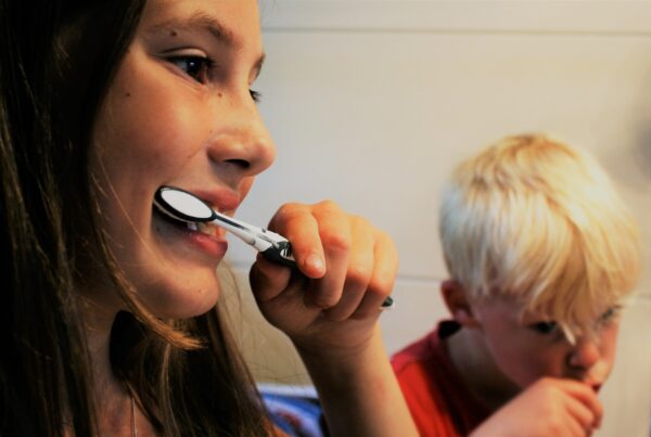 two-kids-brushing-teeth-and-gums