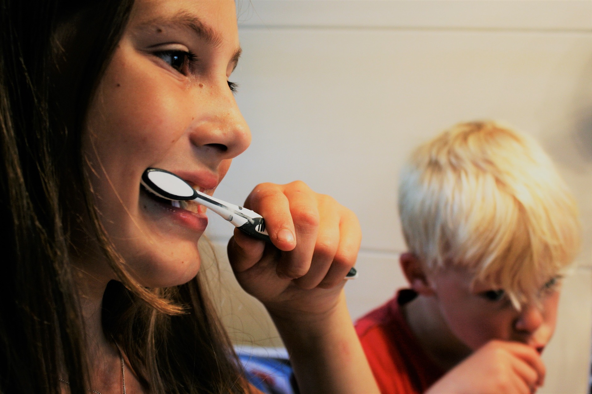 two-kids-brushing-teeth-and-gums